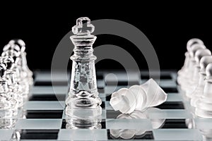 Glass chess pieces on a glass chessboard