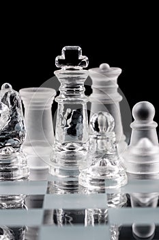 Glass chess pieces on a glass chessboard