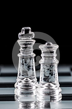 Glass chess pieces on a glass chessboard