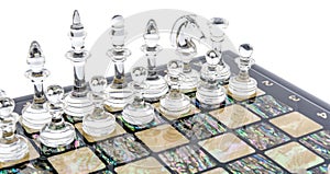 glass chess pieces is standing on board in white