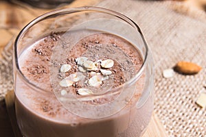 Glass of chocolate milk on table