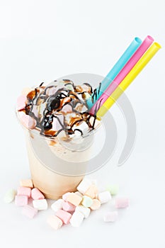 Glass of chocolate milkshake isolated on white background .Vanilla funfetti milkshake with whipped cream and sprinkles