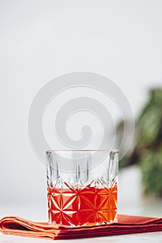 Glass of chocolate red orange negroni, an italian cocktail, an aperitif, first mixed in Firenze, Italy, in 1919, alcoholic bitter