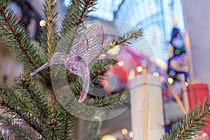 Glass christmas toy hummingbird on Christmas tree.