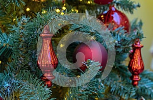 Glass Christmas toy in the shape of a red drop on the Christmas tree.