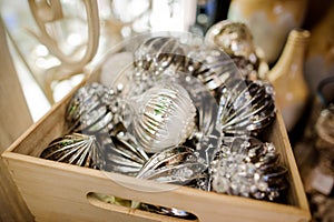 Glass Christmas tree decoration toys in the form of silver balls in a wooden box