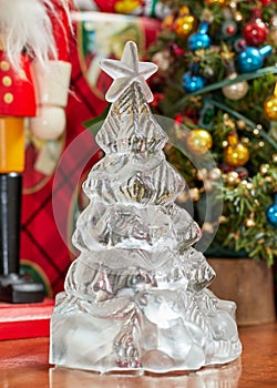 glass christmas tree in front of other decorations