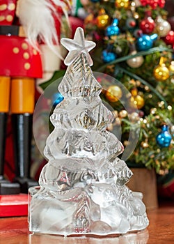 glass christmas tree in front of other decorations