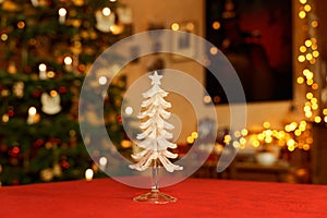 Glass Christmas Tree Table Decoration in Front of Christmassy illuminated Room