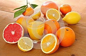 Glass of citrus juice including orange, lemon and grapefruit
