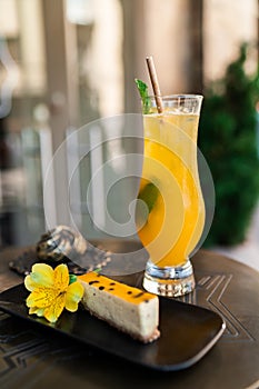 Glass with classic mojito cocktail with lemon and mint, cold refreshing drink or beverage with dessert on bright
