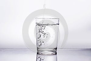 The glass is clean drinking water on a white background