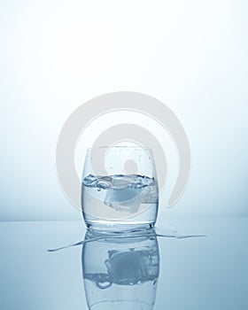 A glass with clean fresh purified water with ice cube. Cool refreshing drink, sip of clean drinking cold water with ice