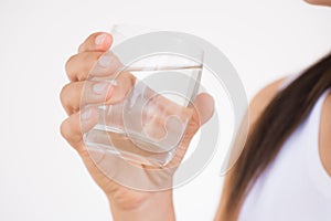 A glass of clean mineral water in woman`s hands.