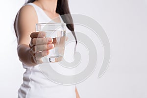 A glass of clean mineral water in woman`s hands. Concept of environment protection, healthy drink and healthcare