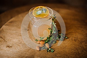 Glass of clear alcoholic cocktail decorated with a slice of orange