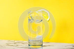 A glass of clear clear water with lemon. Juicy lemon