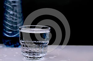 Glass of clear drinking water on a table no people stock photo