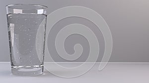Glass of clear water with bubbles on light background - closeup shot