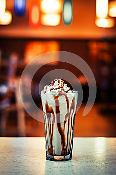 A glass with a cocktail in the interior on a light table