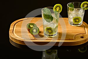 A glass of cocktail sunrise on a wooden board