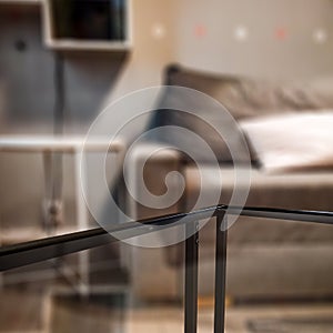 Glass coffee table and copy empty space for your decoration and products. Blurred home interior background.