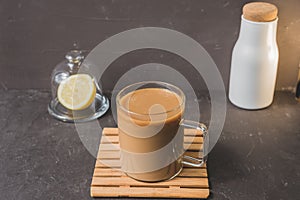 Glass with coffee on wooden tray on dark background/glass with coffee on wooden tray on dark bar counter