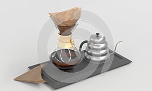 Glass coffeemaker with paper filter and silver drip kettle on black tray, angle view. Clear receptacle with wood collar