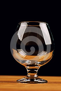 glass for cognac on black background