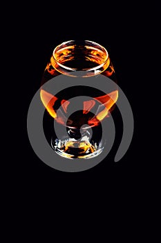 glass with cognac on a black background