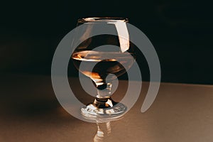 Glass of cognac on a dark background with