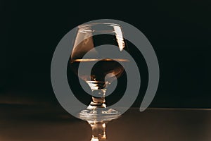 Glass of cognac on a dark background