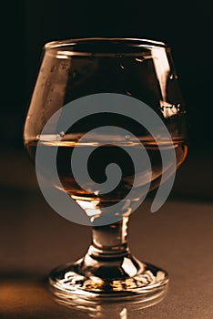 Glass of cognac on a dark background