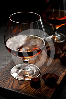 Glass of cognac on dark background, selective focus with  shallow depth of field