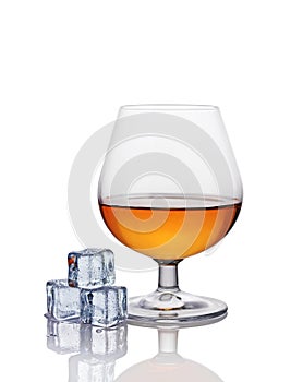 Glass of cognac with ice cube