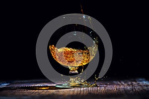 glass with cognac on a wooden background