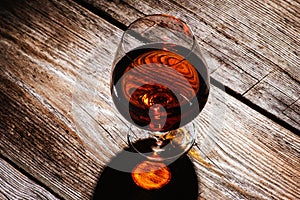 glass with cognac on a wooden background