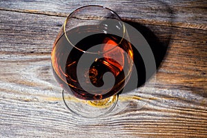 glass with cognac on a wooden background