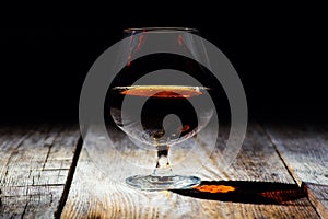 glass with cognac on a wooden background