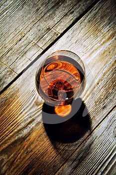 glass with cognac on a wooden background