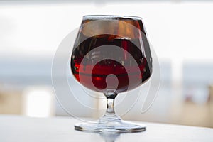 glass of cognac on a wooden table in the bar