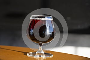 glass of cognac on a wooden table in the bar