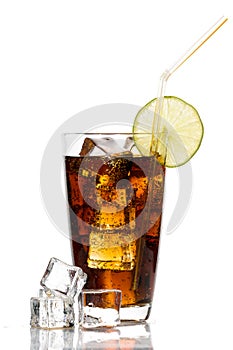 Glass of cola with ice cubes, lime and straw on white backgroun