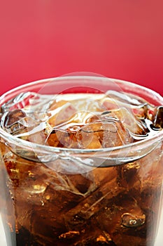 A glass of cola soft drink with ice cubes