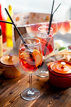 Glass of cold aperol spritz cocktail with Spanish snacks