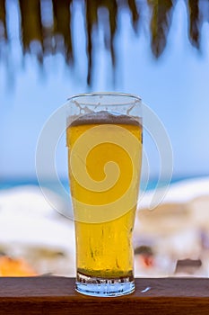 Glass of cold beer at a beach bar