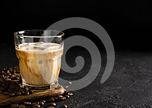 glass cold brew coffee with ice and milk on black or dark background