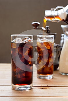 Glass of cold brew coffee on wooden table