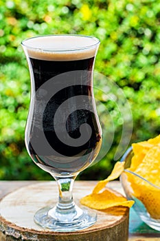 A glass of cold dark beer