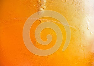 Glass with cold drink beer with condensation ice cool beverage background